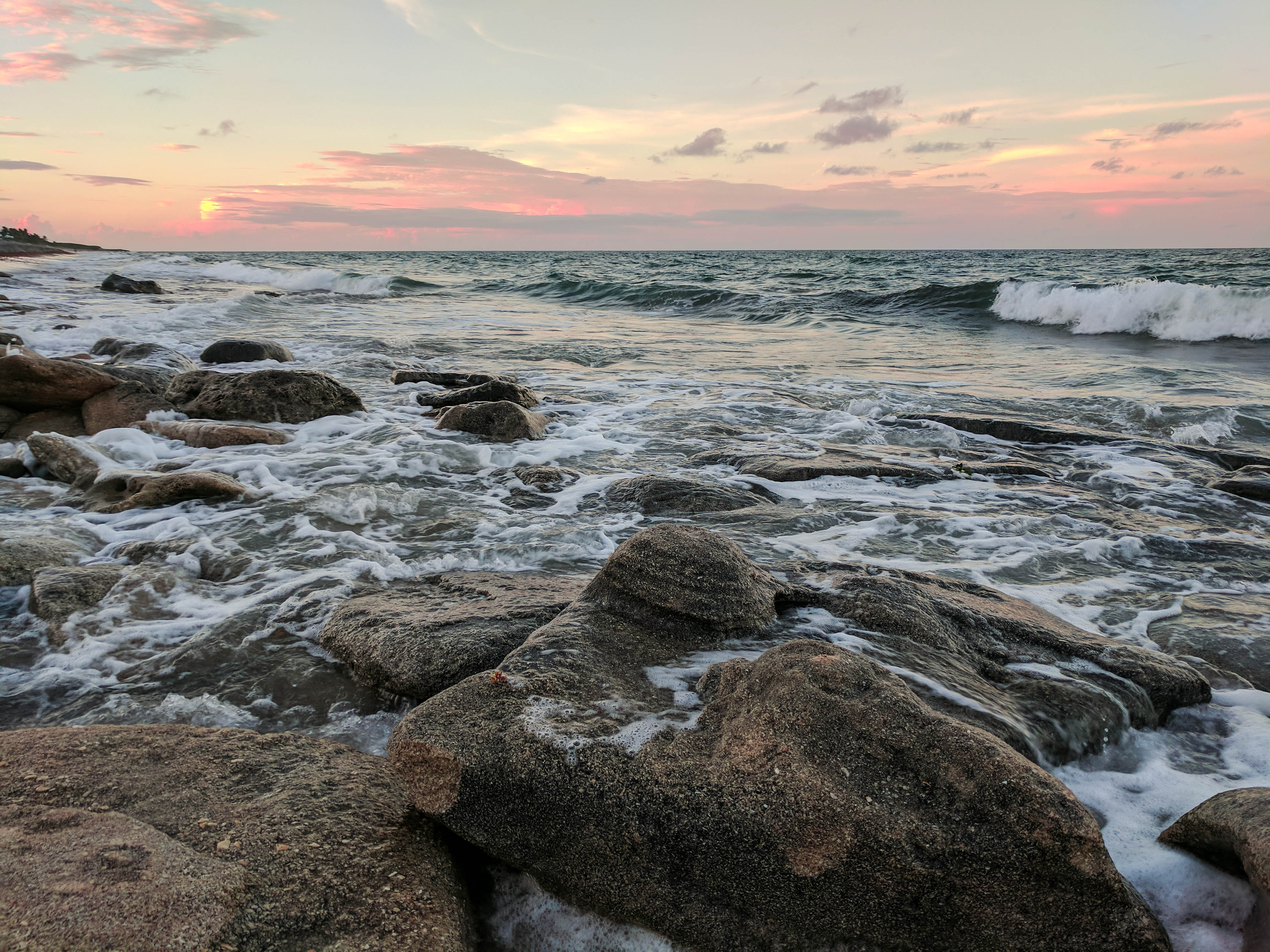 rocks and beach waves during sunset