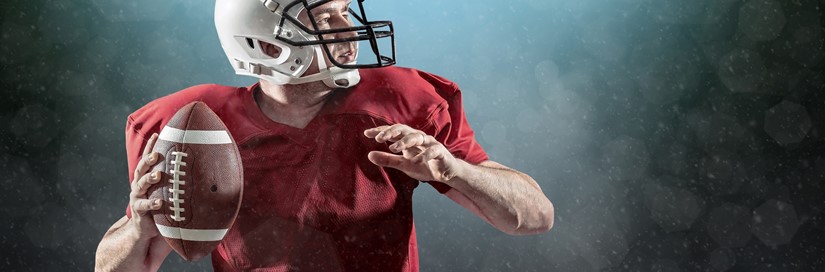 Man throwing football in red uniform